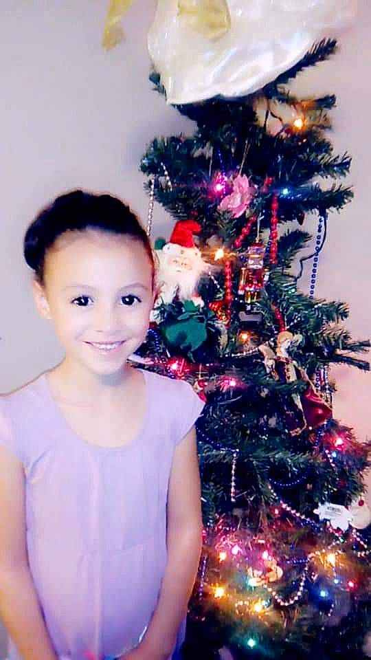 Sarah joined the competition — help win amazing prizes! child, christmas, christmas_decoration, christmas_eve, christmas_lights, christmas_ornament, christmas_tree, conifer, event, fir, holiday, interior_design, joy, person, photography, pine, pine_family, plant, purple, toddler