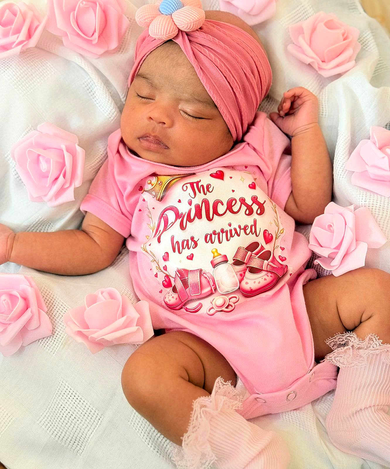 Jannatul Firdaus is registered to the contest to win money with this photo: baby, sleeping, pink, headband, flower, onesie, text, roses, blanket, infant, cute, newborn, soft, peaceful, portrait, child, clothing, skin, hand, footwear