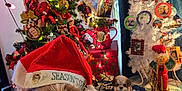 Oscar joined the competition — help win amazing prizes! dog, santa_hat, tinsel, christmas_tree, ornaments, holiday_lights, indoor, plush_toy, blanket, decorations, festive, red_bow, nutcracker, photo_frames, curtains, table, christmas, holiday, pet, cozy