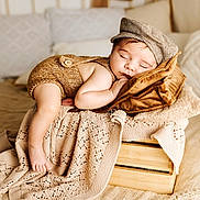 Simon a rejoint le concours — aidez-le/la à gagner de superbes lots ! baby, beige, blanket, brown_cap, child, comfort, cozy, cute, indoor, infant, knitted_clothing, peaceful, pillow, portrait, relaxing, resting, sleeping, soft_texture, warm, wooden_crate
