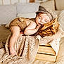 baby, beige, blanket, brown_cap, child, comfort, cozy, cute, indoor, infant, knitted_clothing, peaceful, pillow, portrait, relaxing, resting, sleeping, soft_texture, warm, wooden_crate