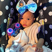 Kayloni is registered to the contest to win money with this photo: baby, blanket, blue, bow, car_seat, child, clothing, cute, face, hand, headwear, indoor, infant, light, person, pink, polka_dot, portrait, soft, toy