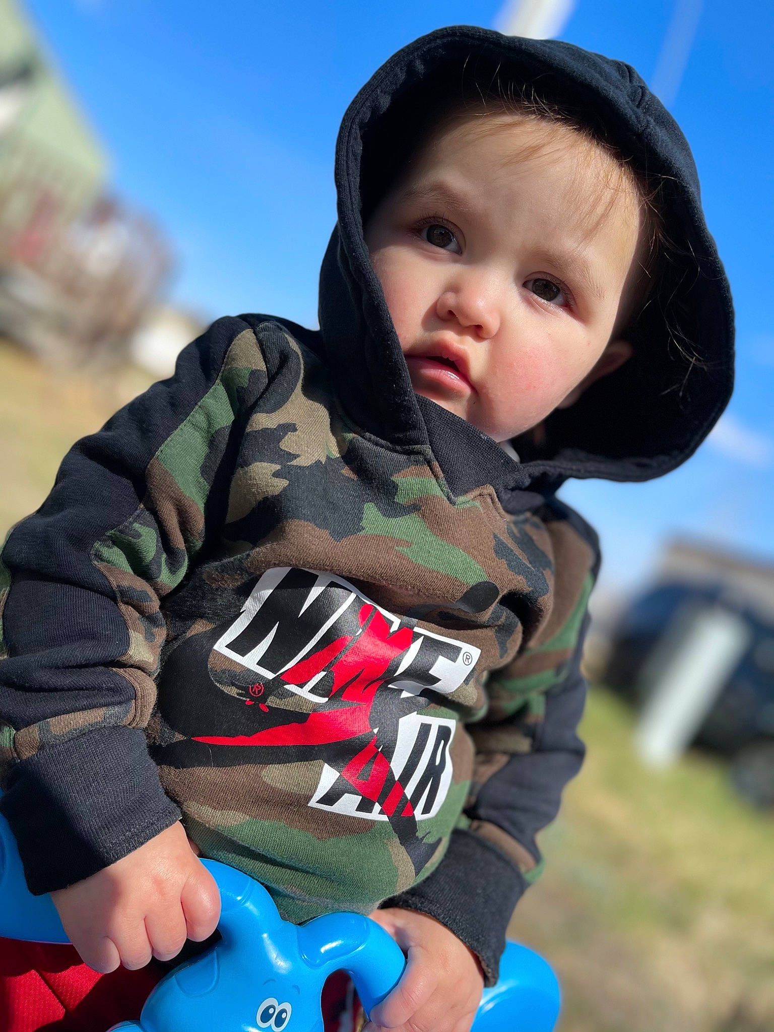 Acelyn is registered to the contest to win money with this photo: baby, blue, child, cloud, cool, facial_expression, flash_photography, fun, grass, happy, leisure, people_in_nature, person, personal_protective_equipment, photograph, recreation, sky, toddler, toy, travel