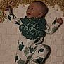 Knox is registered to the contest to win money with this photo: baby, infant, smiling, onesie, shamrock, st_patricks_day, bib, cereal, blanket, lying_down, happy, cute, clothing, celebration, holiday, child, face, head, playful, indoors