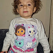 Lavayah joined the competition — help win amazing prizes! cartoon, cats, child, clothing, couch, curly_hair, drool, expression, face, furniture, hair, indoor, long_sleeve, pajamas, pants, person, shirt, sitting, toddler, wall