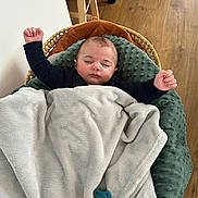 Arthur participe au concours pour gagner de l'argent avec cette photo : baby, sleeping, blanket, pacifier, baby_lounger, wooden_floor, arms_up, cozy, infant, face, clothing, indoors, child, comfort, rest, soft_texture, peaceful, cute, nap, furniture