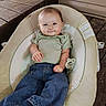 baby, infant, smile, clothing, jeans, green_shirt, baby_seat, wooden_floor, barefoot, cute, child, indoors, comfortable, portrait, small_hands, small_feet, happy, young_child, casual, relaxed