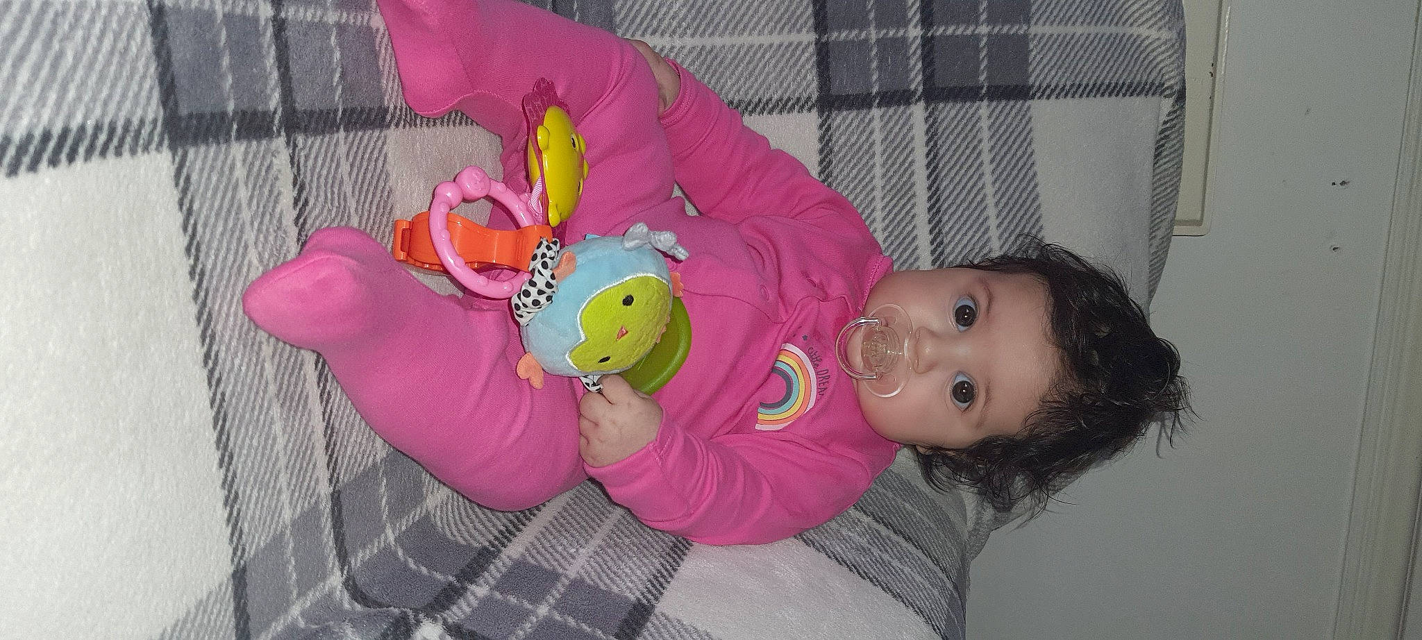 Kaya is registered to the contest to win money with this photo: baby, baby_playing_with_toys, baby_products, baby_toddler_clothing, baby_toys, insect, mesh, party_supply, person, pink, plaid, plush, stuffed_toy, sweater, tartan, textile, toddler, toy