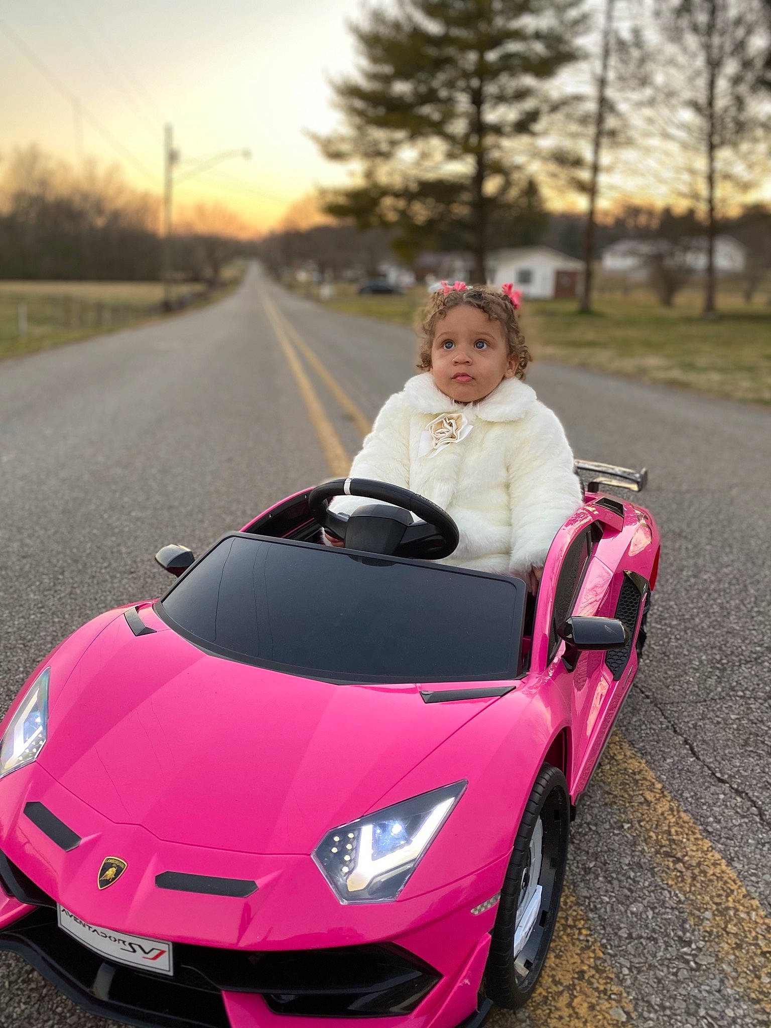 Kahlani is registered to the contest to win money with this photo: alloy_wheel, automotive_design, automotive_exterior, automotive_lighting, automotive_tire, bumper, car, grille, hood, infrastructure, light, motor_vehicle, orange, person, photograph, plant, sky, tire, tree, vehicle