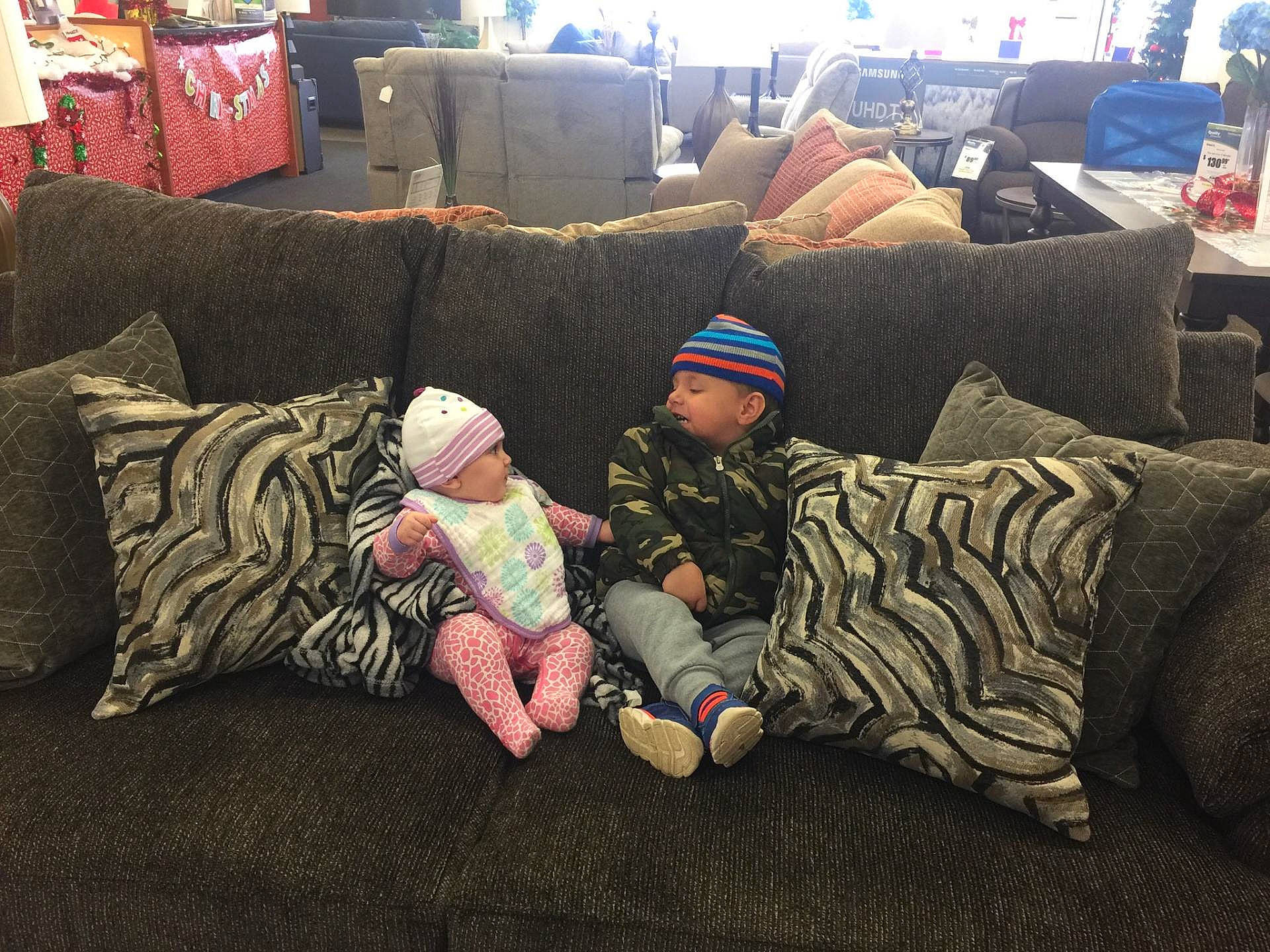Kaleb is registered to the contest to win money with this photo: child, comfort, couch, flooring, furniture, headwear, living_room, mountain, nap, person, room, sitting, sky, sleep, tree