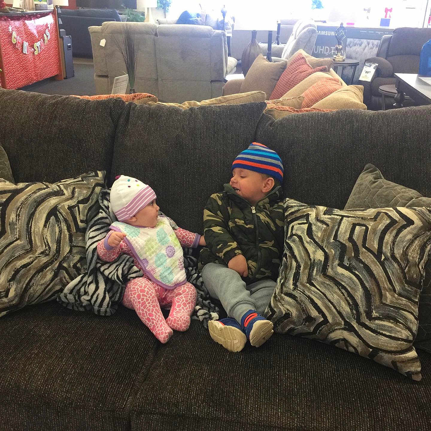 Kaleb is registered to the contest to win money with this photo: child, comfort, couch, flooring, furniture, headwear, living_room, mountain, nap, person, room, sitting, sky, sleep, tree