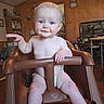Jane joined the competition — help win amazing prizes! baby, child, high_chair, diaper, indoor, wooden_wall, blue_eyes, smile, arm, leg, floor, furniture, room, person, infant, skin, expression, hair, hand, seat