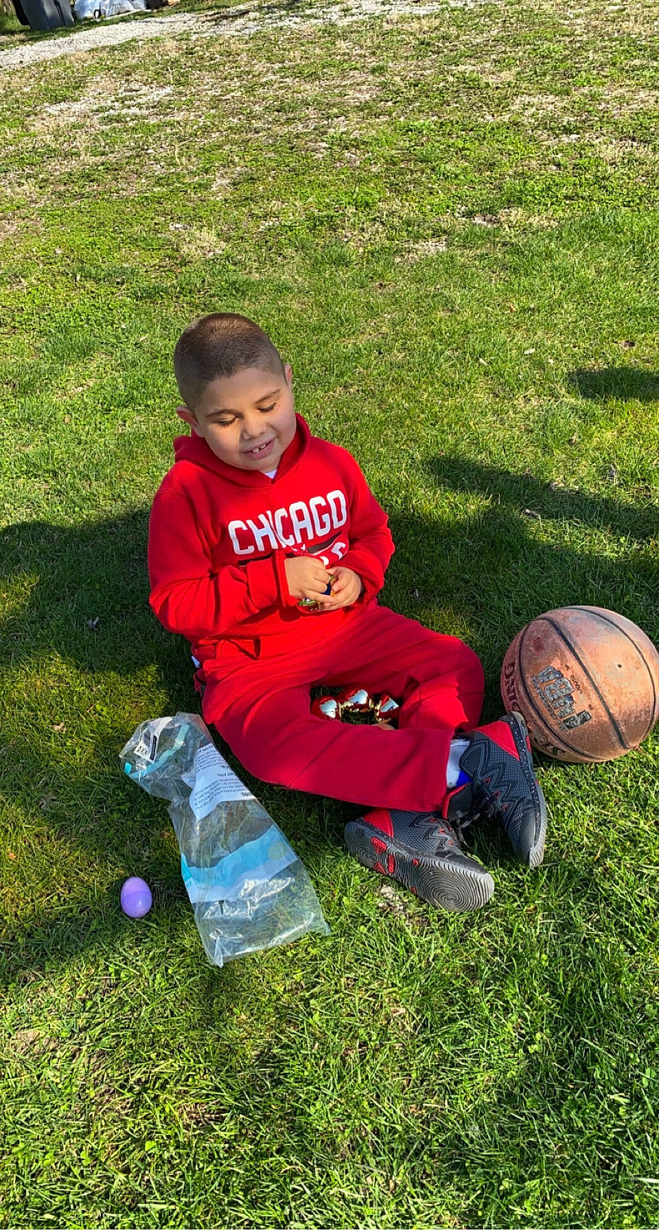 Cruz joined the competition — help win amazing prizes! ball, child, football, fun, grass, grass_family, grassland, happy, lawn, leisure, mammal, people_in_nature, person, plant, recreation, sitting, sneakers, sports_equipment, t_shirt, toddler