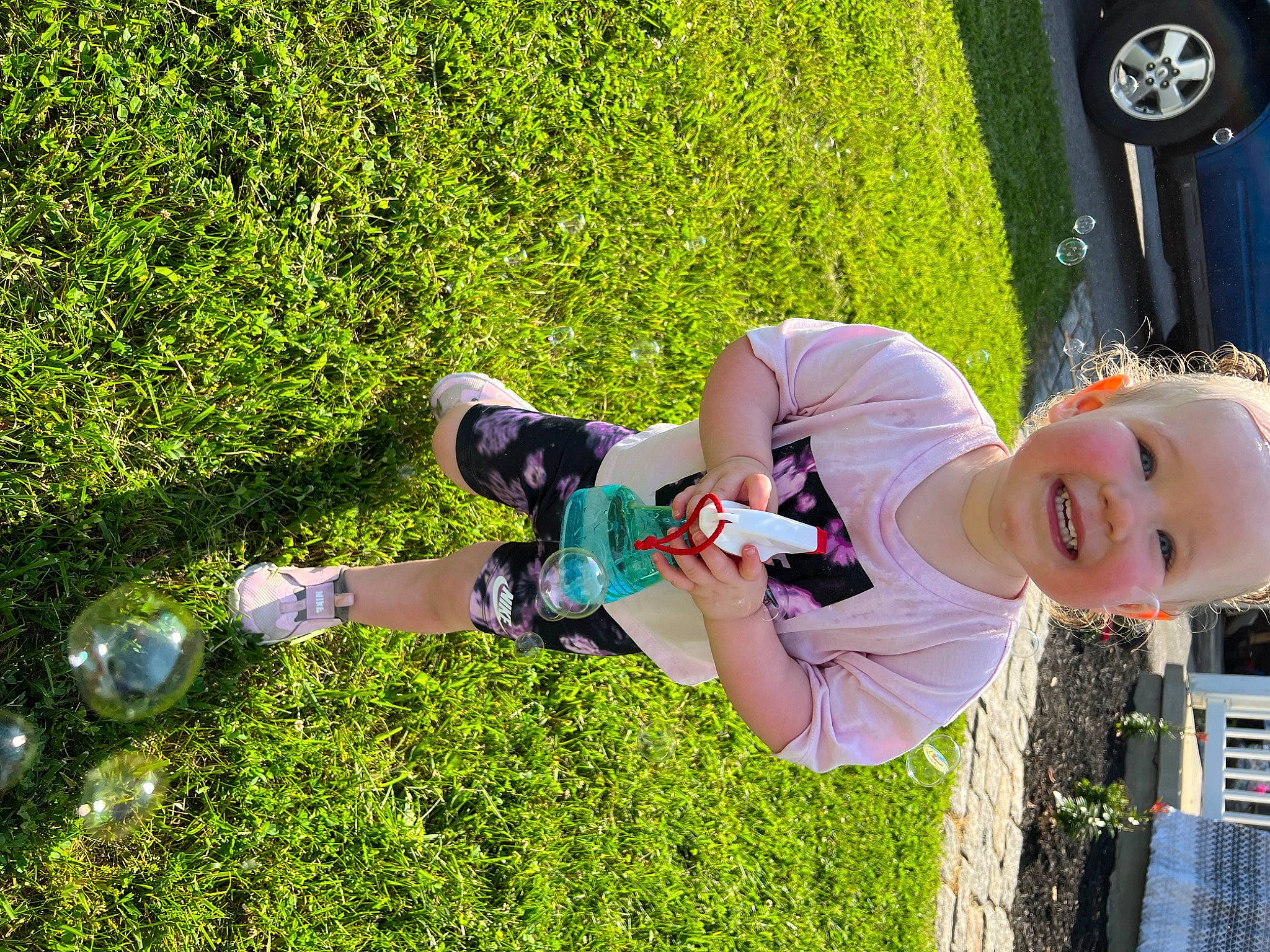 Addy joined the competition — help win amazing prizes! automotive_lighting, automotive_tire, car, fun, grass, green, groundcover, happy, joy, lawn, leisure, people_in_nature, person, plant, recreation, shorts, shrub, smile, tire, toddler