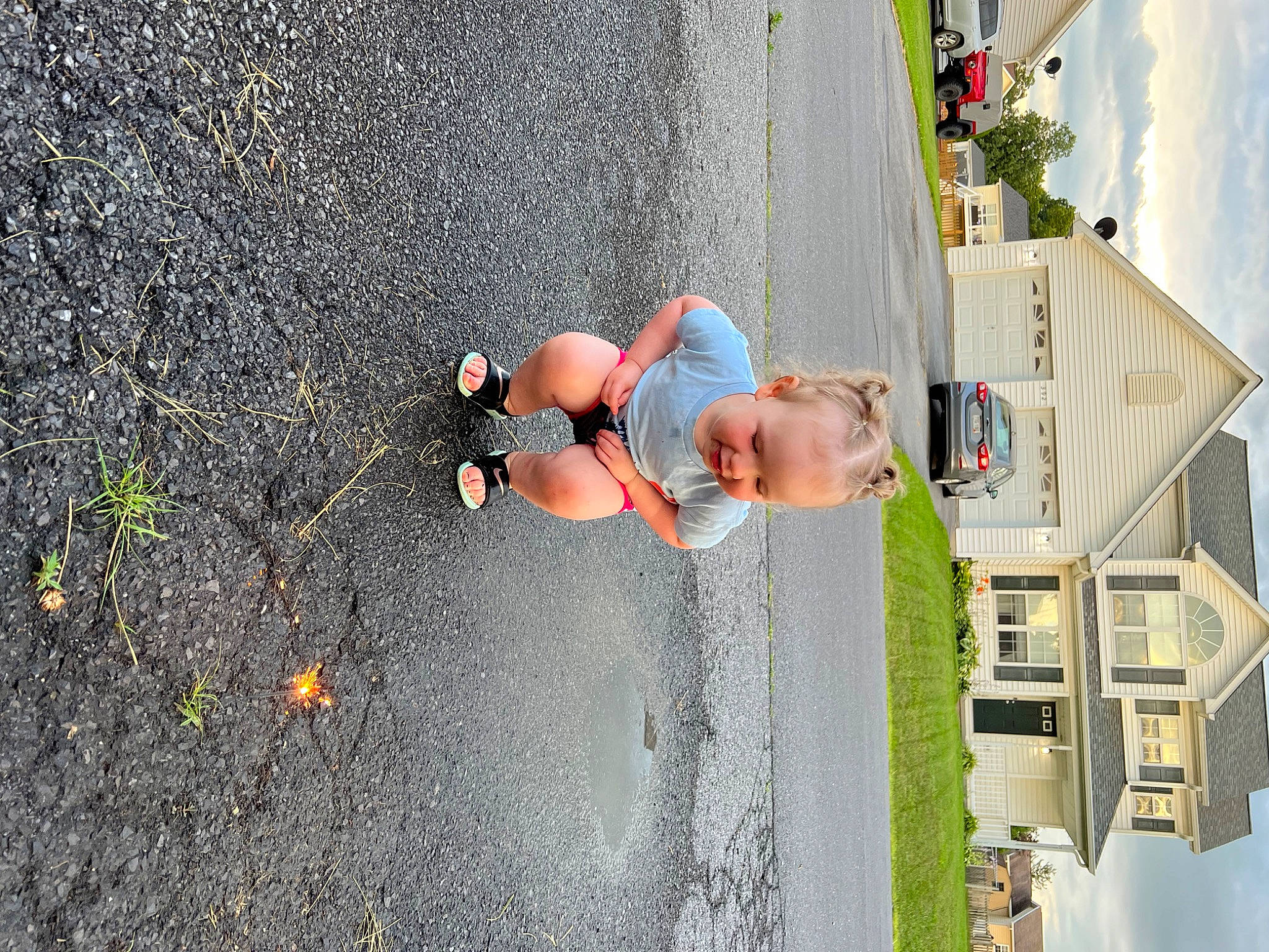 Addy is registered to the contest to win money with this photo: asphalt, child, concrete, fun, house, leisure, person, plant, recreation, road, road_surface, shadow, sidewalk, sky, tar, toddler, travel, tree, wall, water