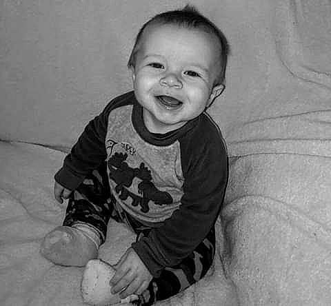 Kyson is registered to the contest to win money with this photo: arm, baby, black, black_and_white, cheek, child, eye, face, facial_expression, happy, head, iris, laugh, monochrome, people, person, sitting, skin, smile, toddler