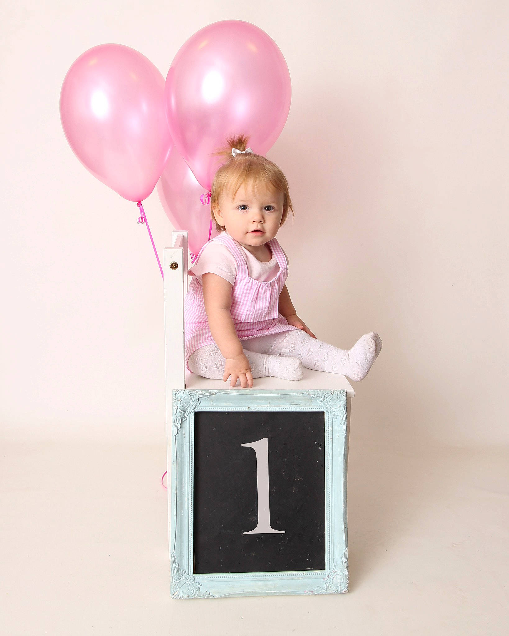 Blossom joined the competition — help win amazing prizes! balloon, child, furniture, party, party_supply, person, pink, sitting, smile, toddler, toy