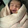 Izabella is registered to the contest to win money with this photo: baby, blanket, child, closed_eyes, cozy, cute, face, happy, indoor, infant, newborn, person, portrait, resting, sleepy, smiling, soft_texture, towel, warm, wrapped
