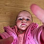 baby, casual_clothing, child, close_up, curious, cute, expressionless, face, human, indoor, infant, people, person, pink_jacket, playful, portrait, reaching_hand, toddler, wooden_floor, young_child