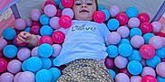Eliza is registered to the contest to win money with this photo: child, ball_pit, colorful_balls, pink_balls, blue_balls, red_balls, polka_dot_pants, white_shirt, love_text, bunny_graphic, outdoor, pavement, play, relaxation, happy_child, casual_clothing, toy, fun, kid, summer