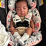baby, sleeping, car_seat, floral_pattern, white_socks, infant, child, cute, peaceful, cushion, soft, comfortable, nap, straps, closeup, indoors, portrait, adorable, young, resting