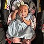 baby, infant, car_seat, pacifier, headband, dress, feet, hand, face, child, floral_pattern, fabric, clothing, comfort, cute, indoor, portrait, newborn, seat, accessory