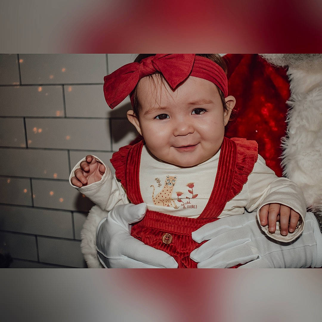 Gabriella joined the competition — help win amazing prizes! baby, baby_toddler_clothing, cap, child, christmas, comfort, costume_hat, event, fictional_character, fur, happy, hat, head, headwear, joy, outerwear, pattern, person, sitting, sleeve