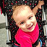 Luther joined the competition — help win amazing prizes! baby, child, infant, smiling, happy, portrait, stroller, sitting, indoors, pink_shirt, blue_eyes, blonde_hair, face, hand, patterned_fabric, polka_dots, baby_clothing, harness, close_up, photography