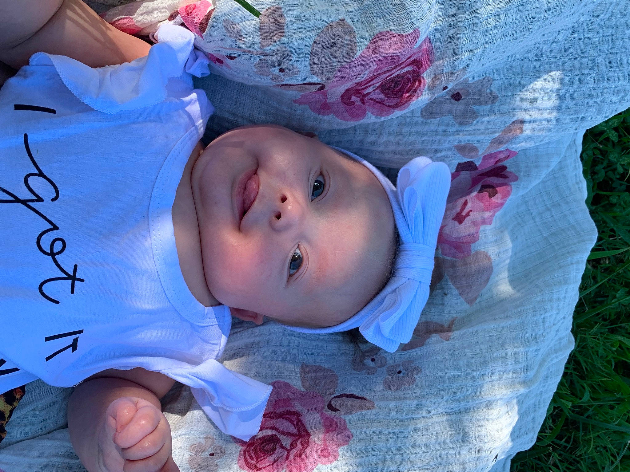 Blakely is registered to the contest to win money with this photo: baby, baby_toddler_clothing, cheek, child, fun, grass, happy, hat, headwear, iris, leisure, mouth, pattern, person, pink, plant, red, skin, smile, textile