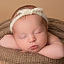 baby, newborn, sleeping, headband, blanket, soft_texture, closeup, peaceful, infant, cute, face, resting, warm_colors, skin, portrait, tiny, wrapped, cozy, hands, knitted