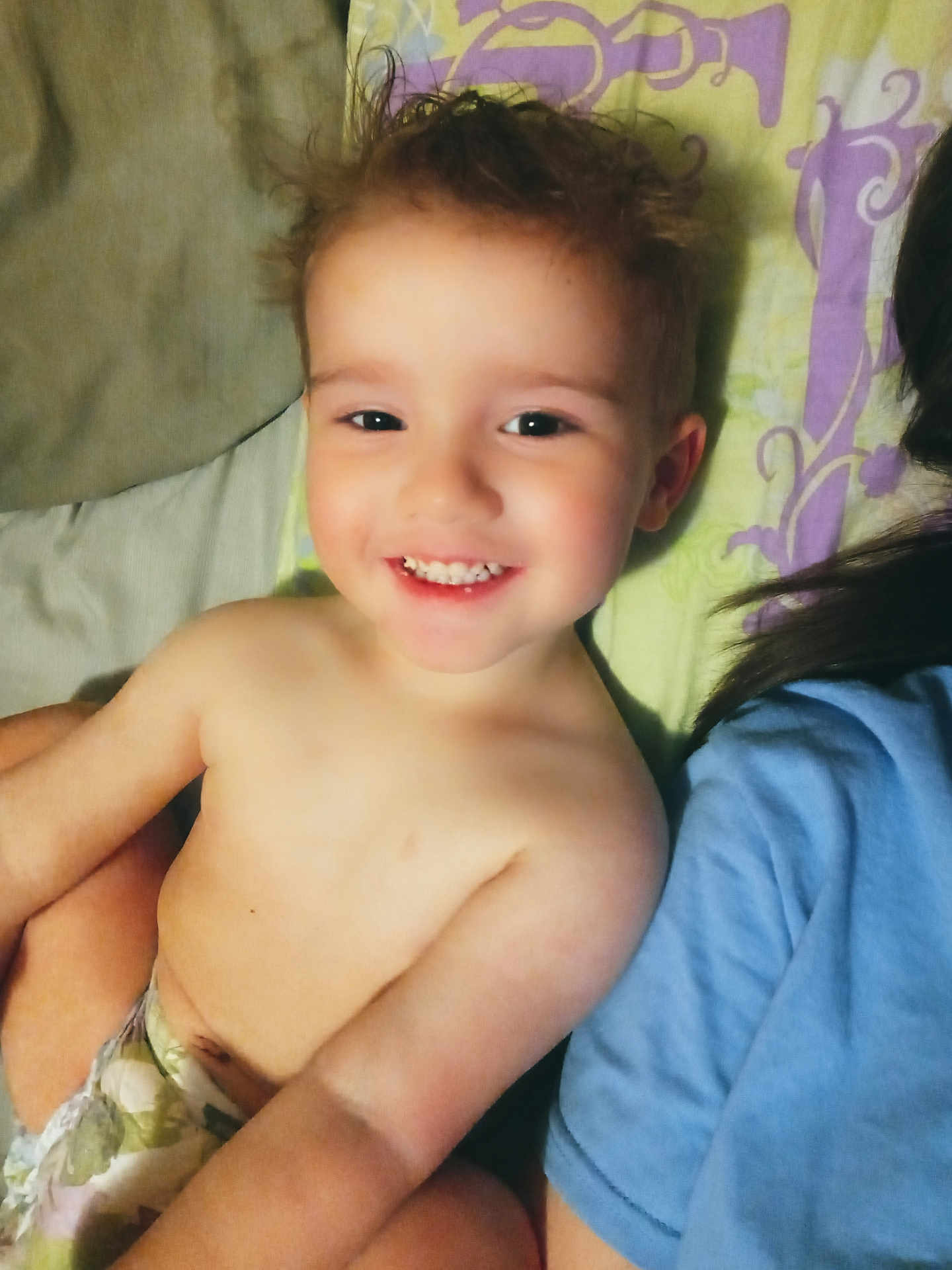 David joined the competition — help win amazing prizes! toddler, child, smiling, face, bare_chest, diaper, blanket, pattern, hair, joyful, person, indoors, lying_down, closeup, happy, skin, head, shoulder, blue_shirt, candid