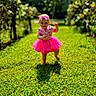 baby, bow, child, dress, garden, girl, grass, headband, lawn, nature, outdoor, pink, portrait, smiling, standing, sunlight, toddler, trees, tutu, walking