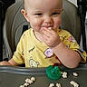 toddler, child, high_chair, snack, food, pacifier, yellow_shirt, indoor, smile, face, hand, table, baby, cute, happy, eating, seat, playful, young_child, portrait