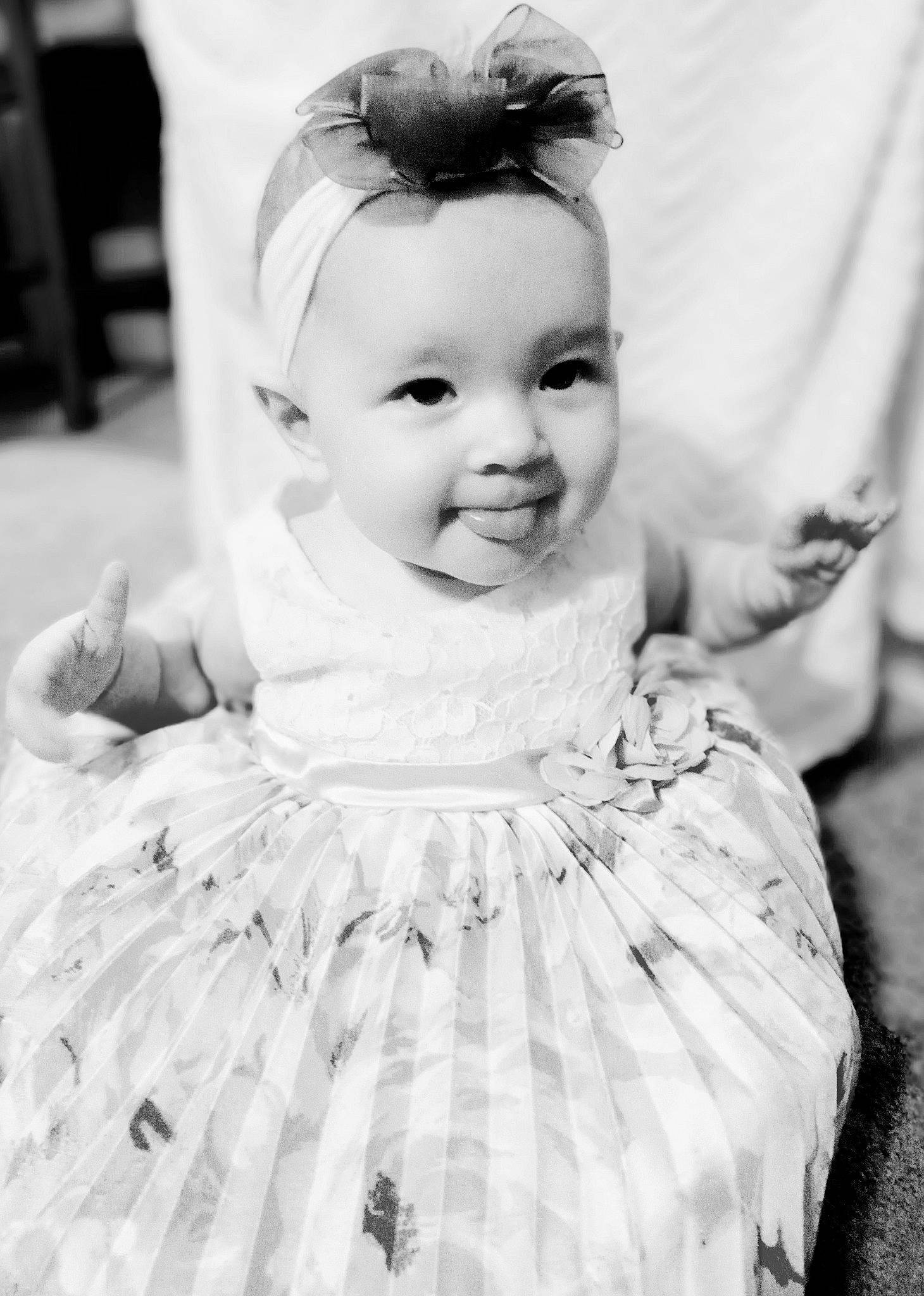 Raelee is registered to the contest to win money with this photo: baby, baby_toddler_clothing, black_and_white, dress, eye, eyelash, face, flash_photography, hair, hairstyle, happy, iris, joy, one_piece_garment, person, photograph, skin, sleeve, smile, style