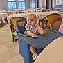 Kelyana a rejoint le concours — aidez-le/la à gagner de superbes lots ! baby, high_chair, restaurant, indoor, child, table, chair, lighting, curious, seated, furniture, window, decor, wall_art, floor, clothing, footwear, person, portrait, dining