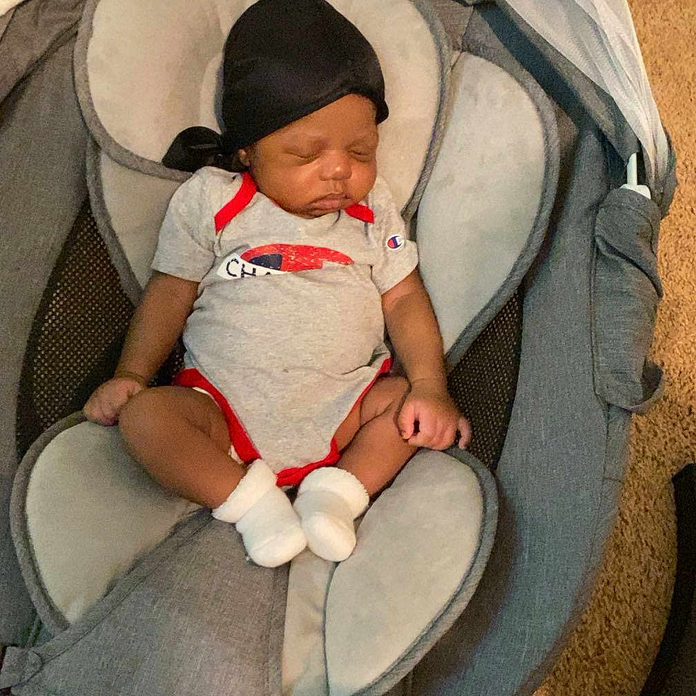 Noah joined the competition — help win amazing prizes! newborn, baby, infant, sleeping, child, car_seat, infant_seat, sitting, portrait, face, closed_eyes, clothing, onesie, socks, blanket, cushion, indoor, carpet, cozy, parenting