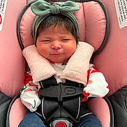 Saelyn is registered to the contest to win money with this photo: baby, infant, car_seat, headband, pink, straps, clothing, smile, face, child, cute, indoors, seatbelt, safety, adorable, young_child, closeup, person, baby_clothes, funny_expression