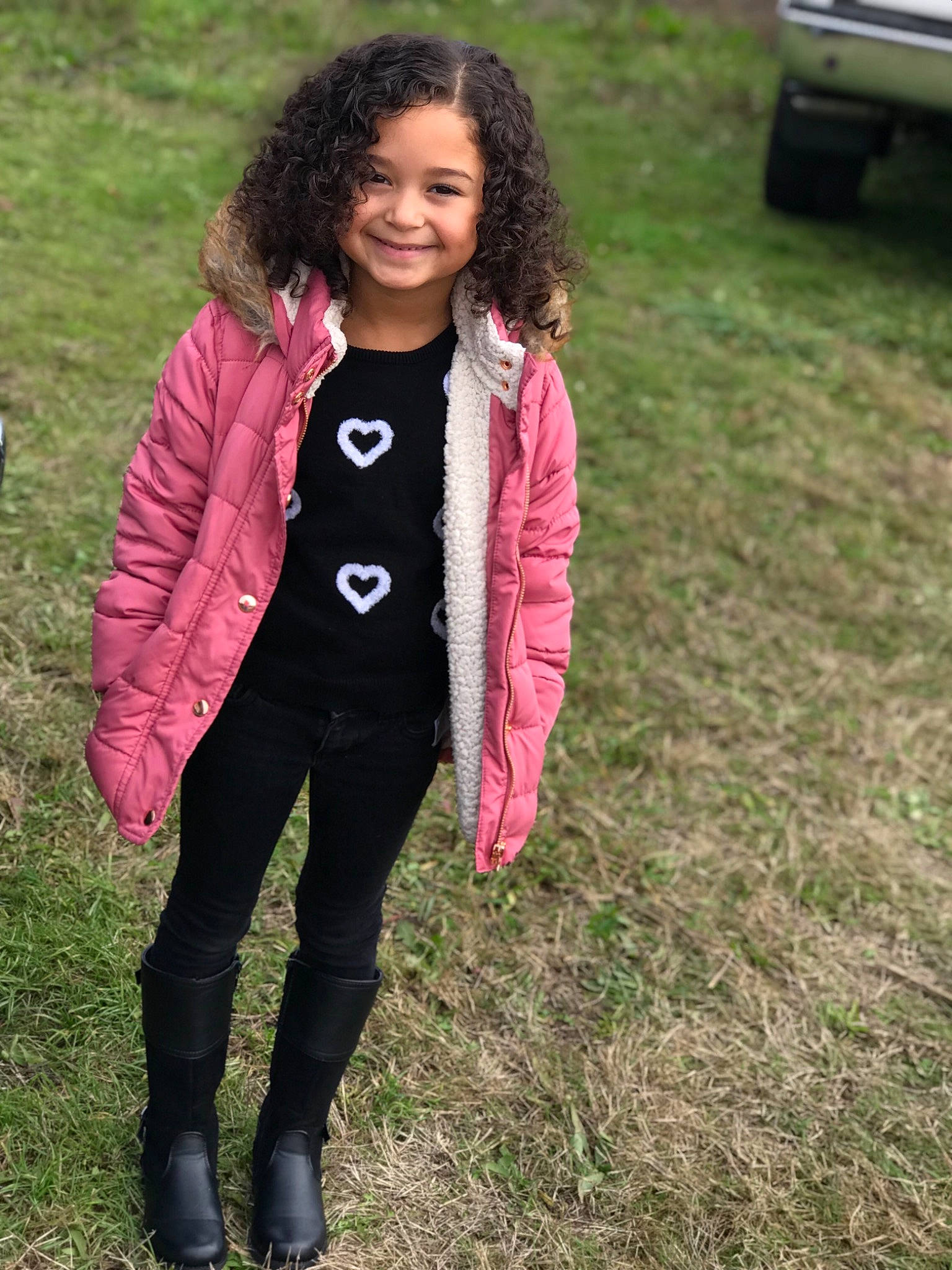 Lillyana is registered to the contest to win money with this photo: child, child_model, clothing, coat, denim, footwear, fun, girl, grass, jacket, jeans, joy, long_hair, outerwear, person, pink, shoe, smile, standing, sweater
