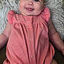 baby, infant, smiling, tongue_out, pink_outfit, pillow, fluffy, cute, lying_down, happy, child, face, skin, arm, legs, indoors, portrait, closeup, person, apparel