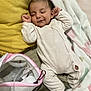 baby, blanket, breast_pump, child, cozy, cute, floor, home, indoor, infant, mesh_pouch, newborn, onesie, pastel_colors, peaceful, relaxing, sleeping, soft_texture, striped_clothing, yellow_pillow