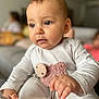 Elena a rejoint le concours — aidez-le/la à gagner de superbes lots ! baby, child, infant, pajamas, pacifier_clip, hand, face, eyes, skin, sitting, indoors, soft_lighting, closeup, cute, young, person, blurred_background, cozy, expression, clothing