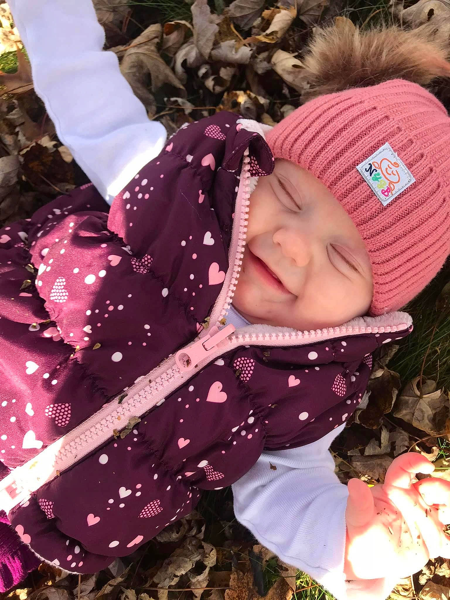 Amelia joined the competition — help win amazing prizes! baby, baby_toddler_clothing, cap, child, fashion_accessory, fun, grass, happy, headwear, jacket, knit_cap, magenta, pattern, people_in_nature, person, pink, plant, purple, smile, toddler