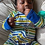 Hayes joined the competition — help win amazing prizes! baby, infant, child, onesie, striped_clothing, hand, thumb_sucking, pacifier, cushion, polka_dot, sleepwear, comfortable, cute, close_up, face, skin, fingers, relaxed, indoor, portrait