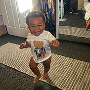 Antoine is registered to the contest to win money with this photo: toddler, child, smiling, indoor, mirror, reflection, tshirt, skeleton, bear, carpet, door, fan, dresser, clothing, barefoot, happy, walking, room, floor, light