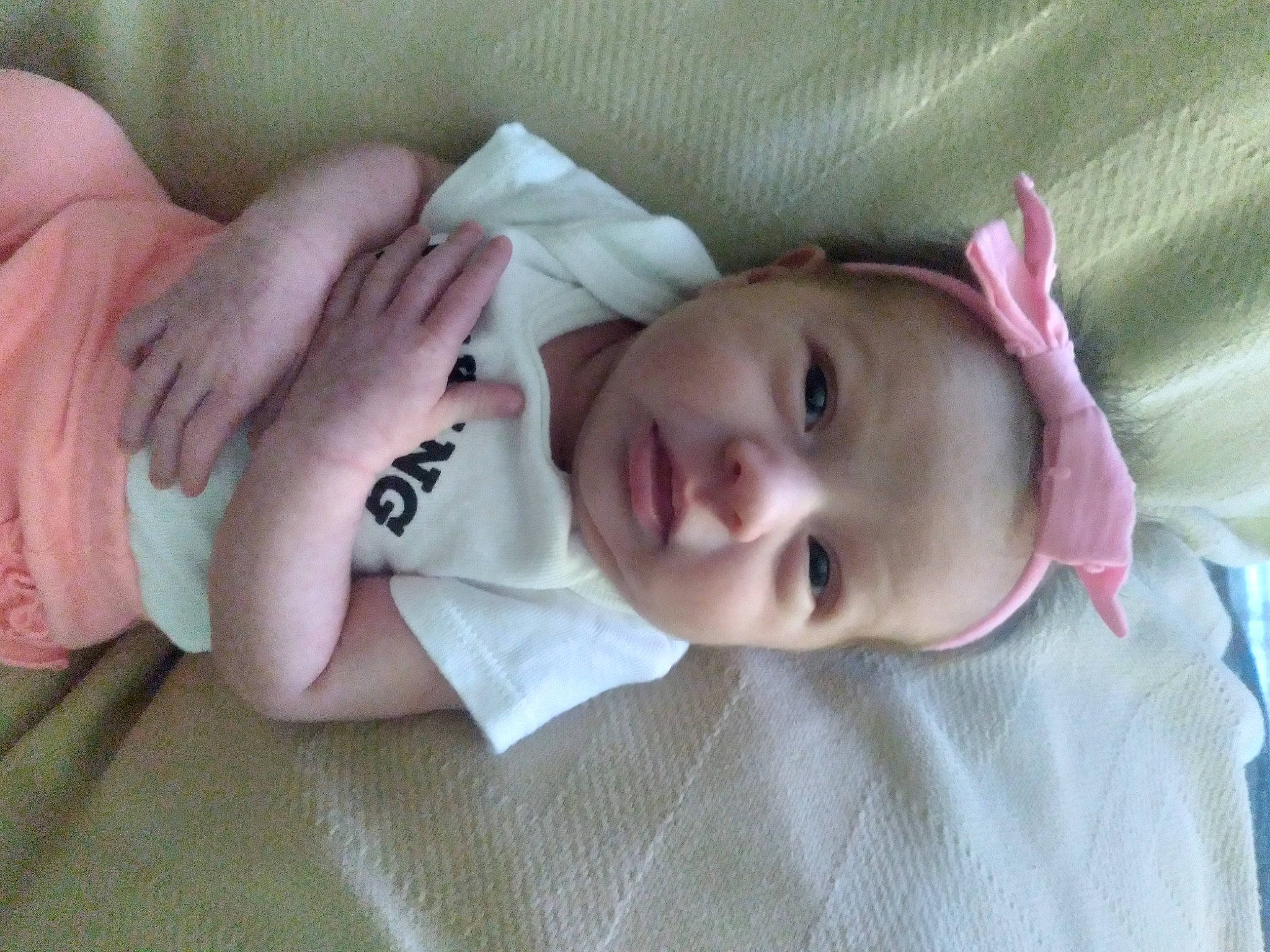 Amara is registered to the contest to win money with this photo: baby, baby_toddler_clothing, cheek, child, chin, comfort, eye, face, finger, gesture, head, linens, lip, mouth, nose, person, skin, sleeve, smile, textile