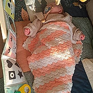 Lisa participe au concours pour gagner de l'argent avec cette photo : baby, blanket, crochet, pacifier, wooden_beads, toy, hanging_toy, sleeping, infant, playmat, colorful, soft, cozy, child, padded, handmade, cute, comfort, indoor, peaceful