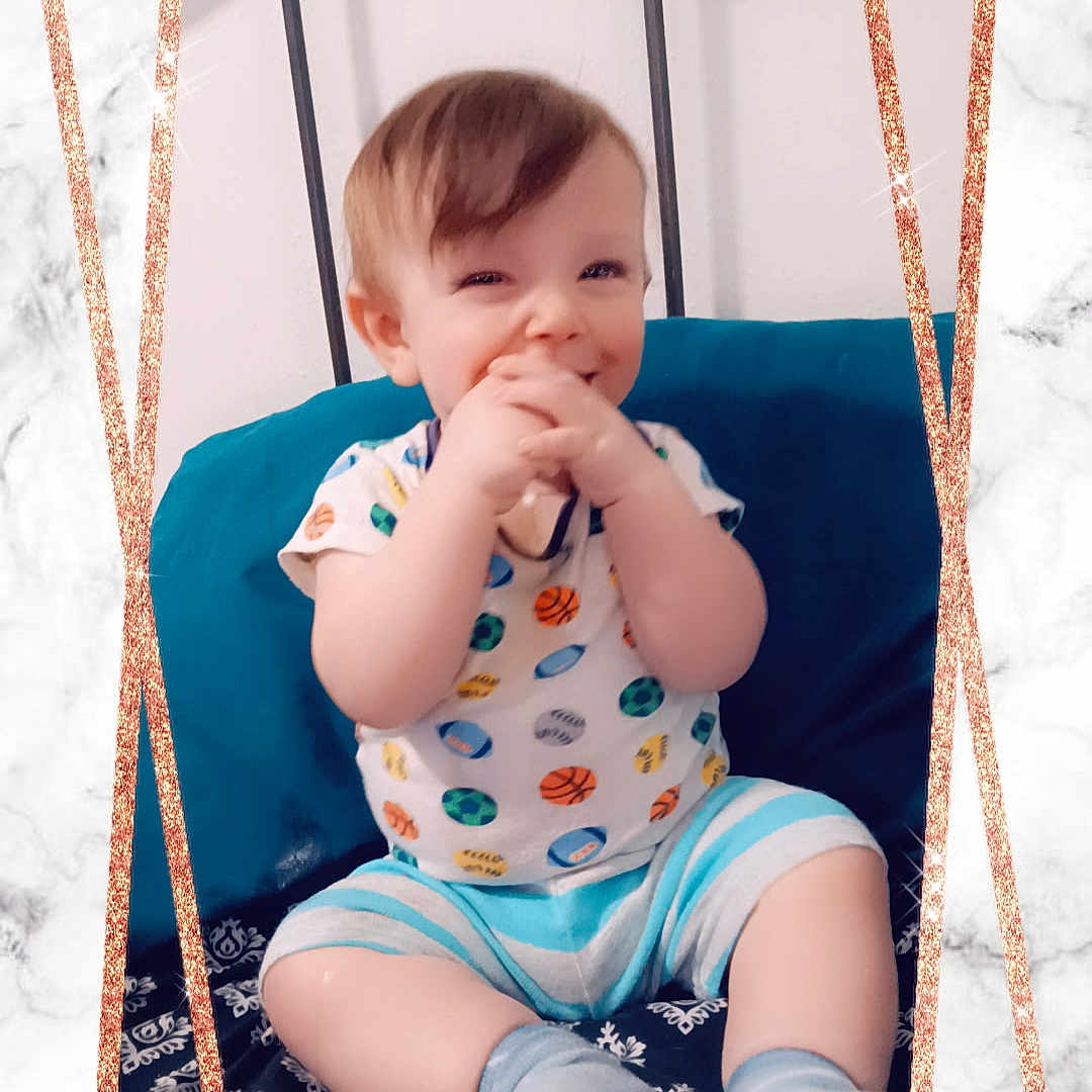 Bowen joined the competition — help win amazing prizes! baby, infant, child, smiling, sitting, cushion, blue_cushion, marble_background, rose_gold_frame, cute, happy, short_hair, sock, striped_shorts, patterned_shirt, indoors, portrait, playful, hands_near_mouth, young_child