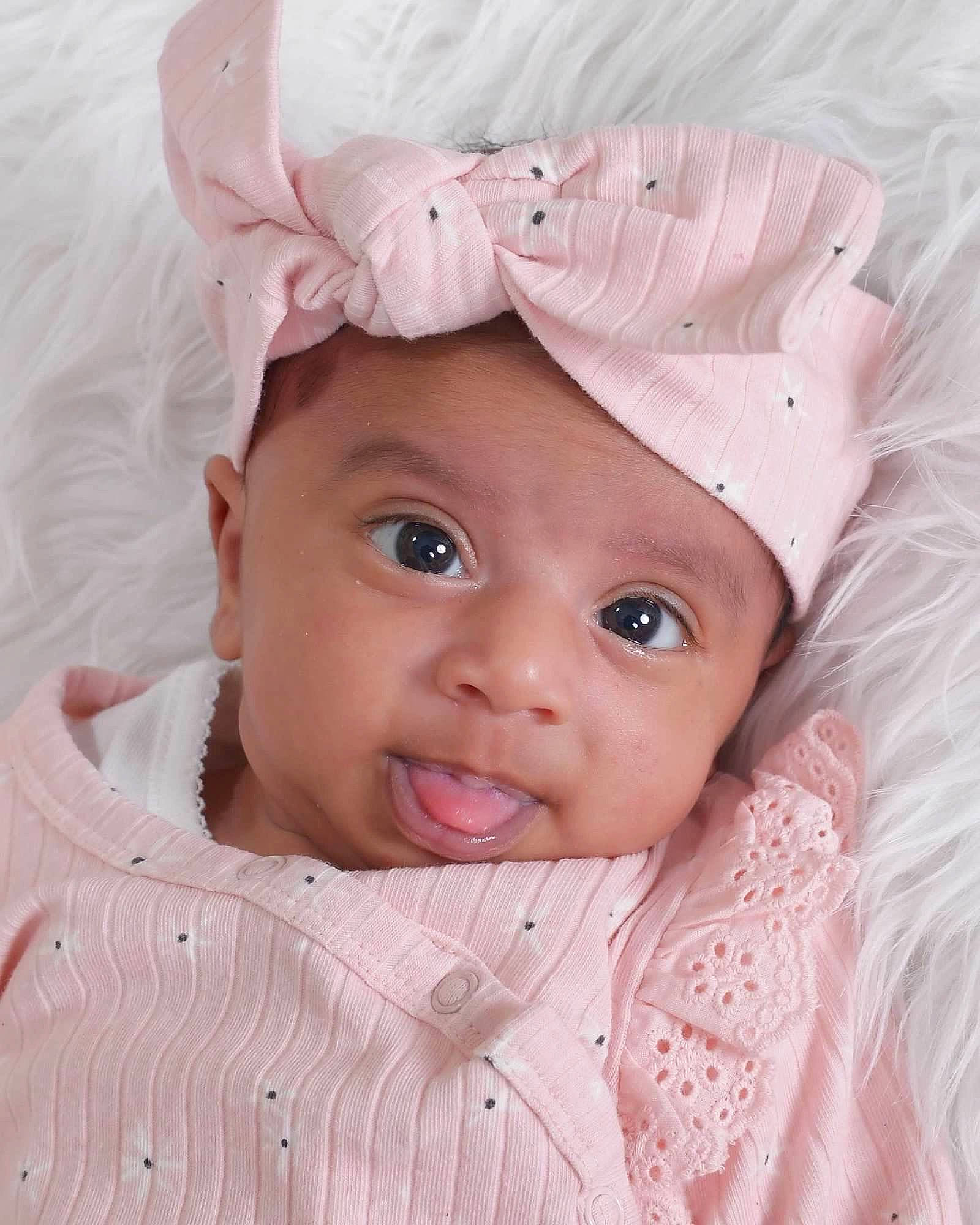 Ayzal is registered to the contest to win money with this photo: baby, baby_toddler_clothing, cheek, child, eyebrow, eyelash, happy, headband, headgear, headpiece, headwear, human_body, iris, lip, magenta, person, pink, skin, sleeve, smile