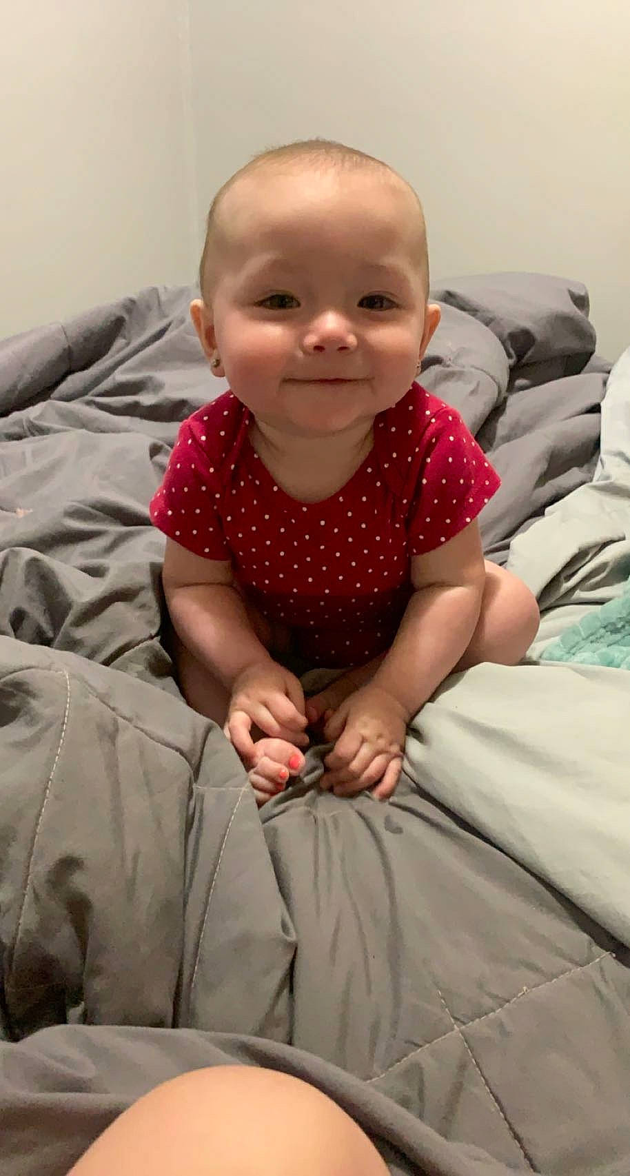 Gracelynn is registered to the contest to win money with this photo: baby, baby_toddler_clothing, cheek, child, clothing, comfort, facial_expression, finger, flooring, happy, joy, linens, mammal, mouth, nose, person, pink, skin, sleeve, smile