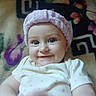 Bayleigh joined the competition — help win amazing prizes! baby, blanket, blue_eyes, child, closeup, cute, face, hand, happy, headband, indoor, infant, lying_down, onesie, pattern, person, portrait, smile, soft_lighting, towel